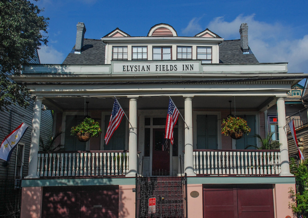 A two-story building with a balcony and columns, displaying the name 'Elysian Fields Inn'